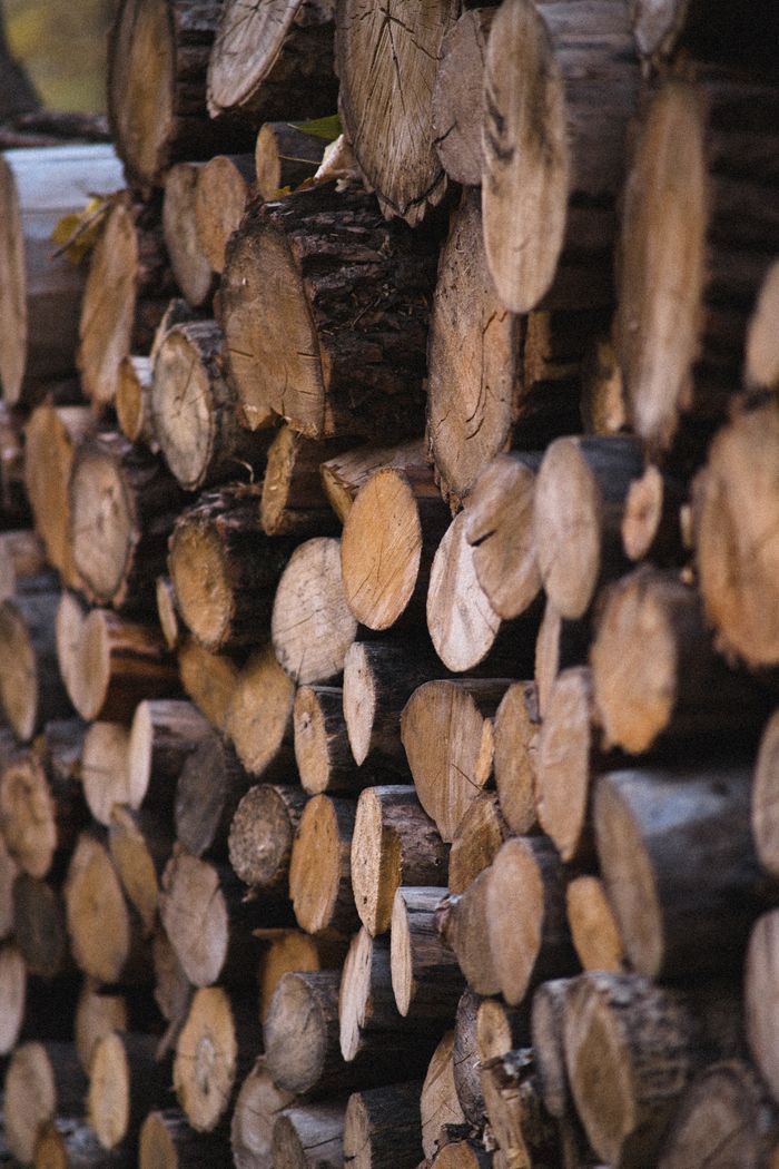 Close-up of stacked timber logs showing natural wood texture and grain.